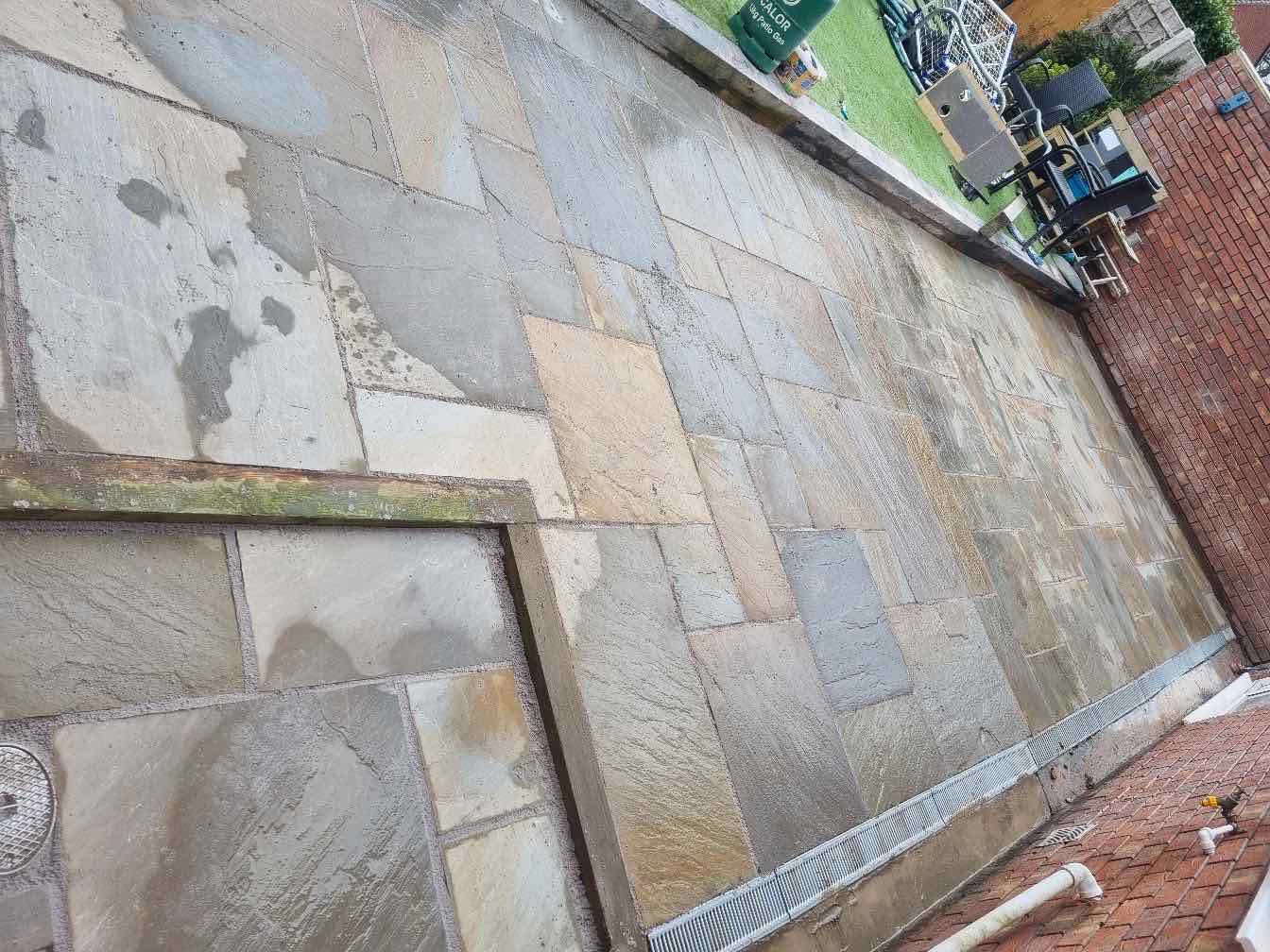Large grey and buff sandstone patio recently laid and pointed